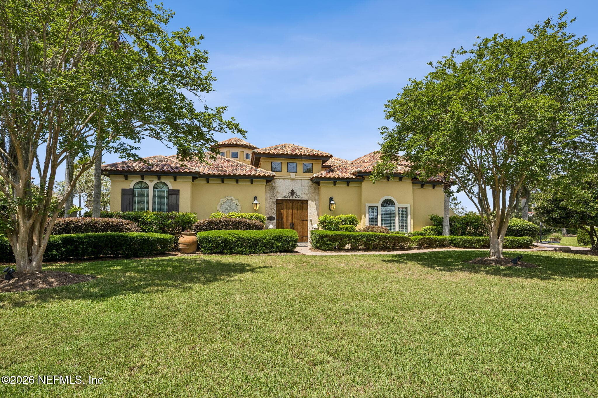 The home’s impressive front exterior showcases timeless architecture, manicured landscaping, and welcoming curb appeal. — 430 ROYAL TERN Road S, Jacksonville Beach, FL 32250