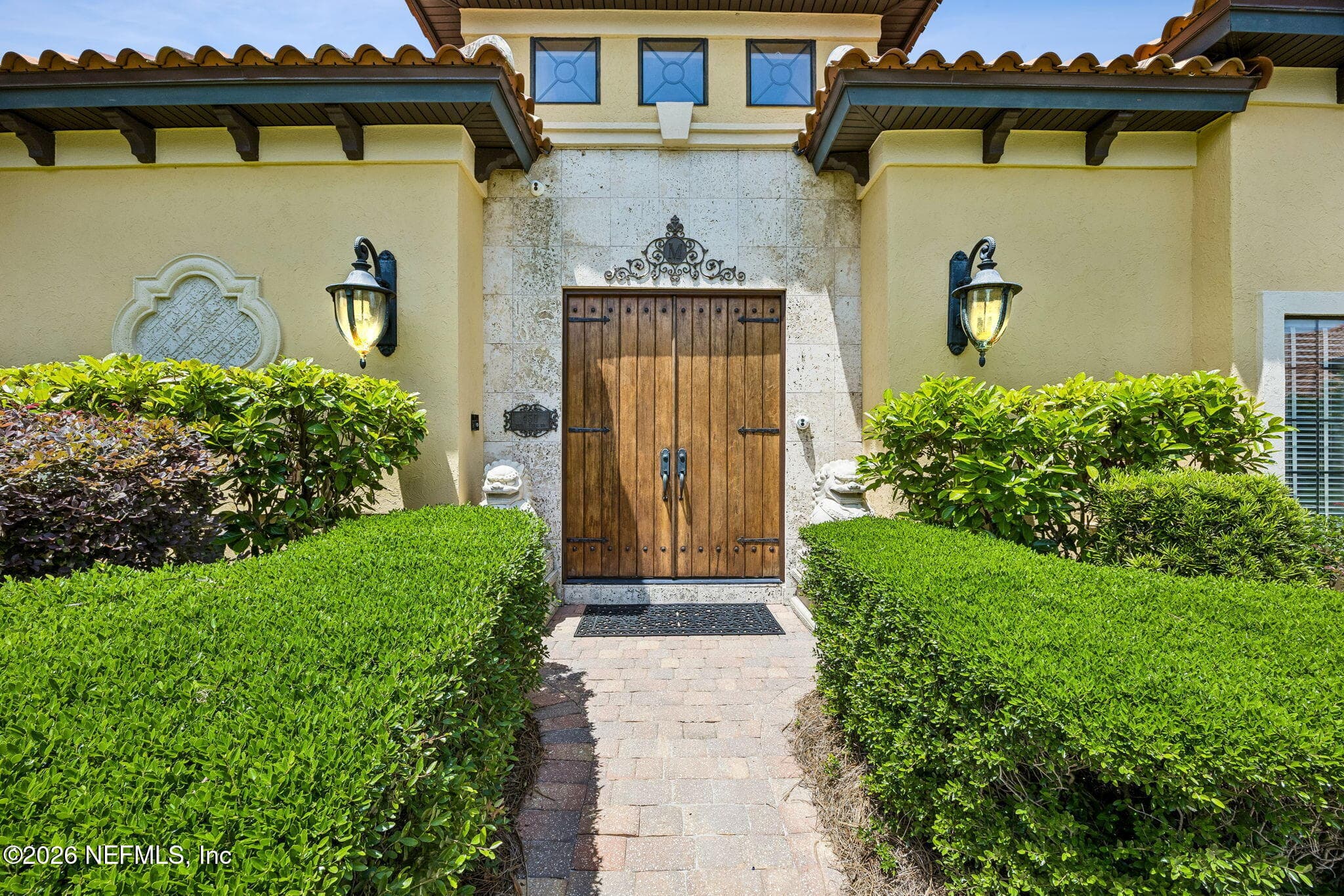 Beautifully crafted wooden door creates a refined and inviting first impression. — 430 ROYAL TERN Road S, Jacksonville Beach, FL 32250