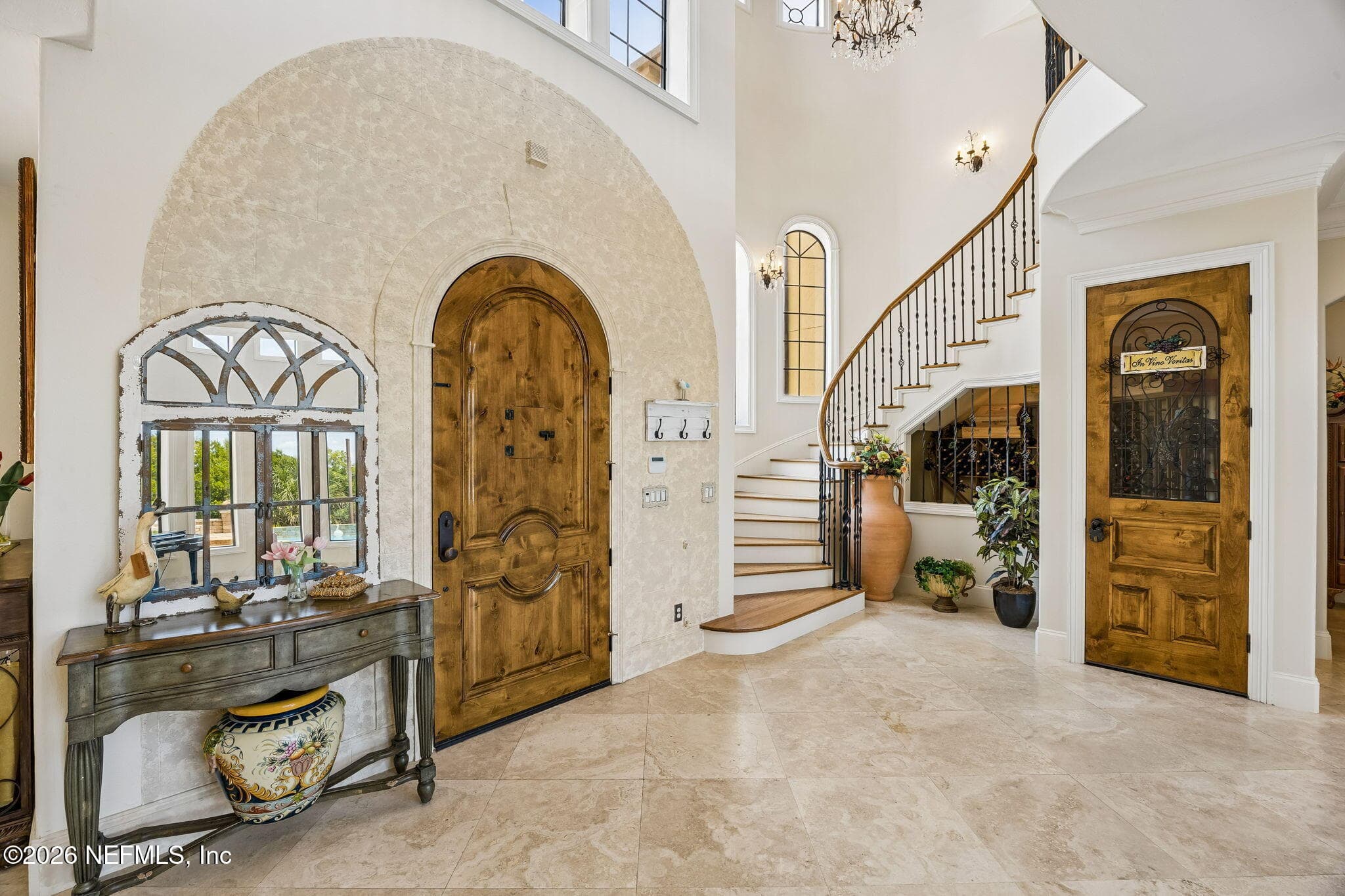 The grand foyer welcomes guests with soaring ceilings, elegant finishes, and a beautifully detailed front door that makes a lasting impression. — 430 ROYAL TERN Road S, Jacksonville Beach, FL 32250
