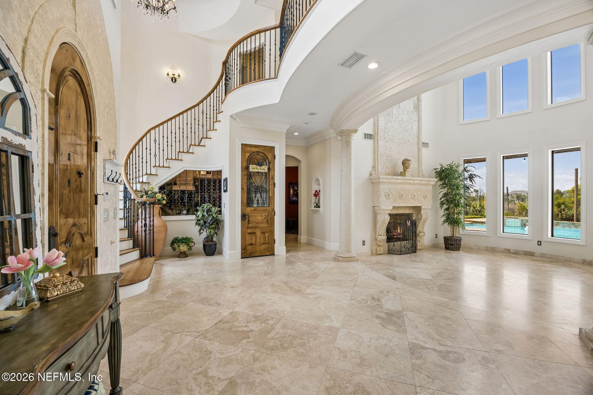 The foyer creates a striking first impression with its grand staircase, refined finishes, and open layout. — 430 ROYAL TERN Road S, Jacksonville Beach, FL 32250