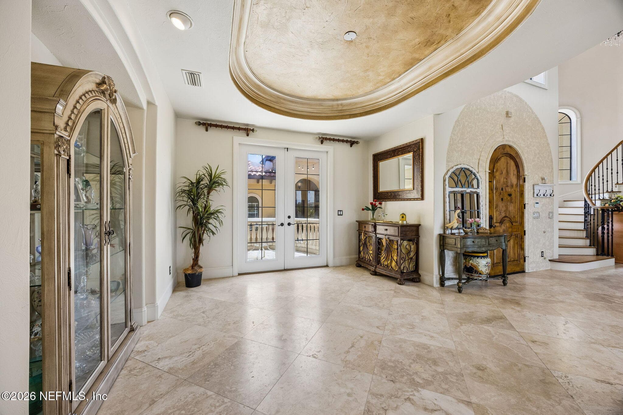 The dining room offers an elegant setting for gatherings, with refined finishes and large windows that fill the space with natural light and views of the outdoors. — 430 ROYAL TERN Road S, Jacksonville Beach, FL 32250