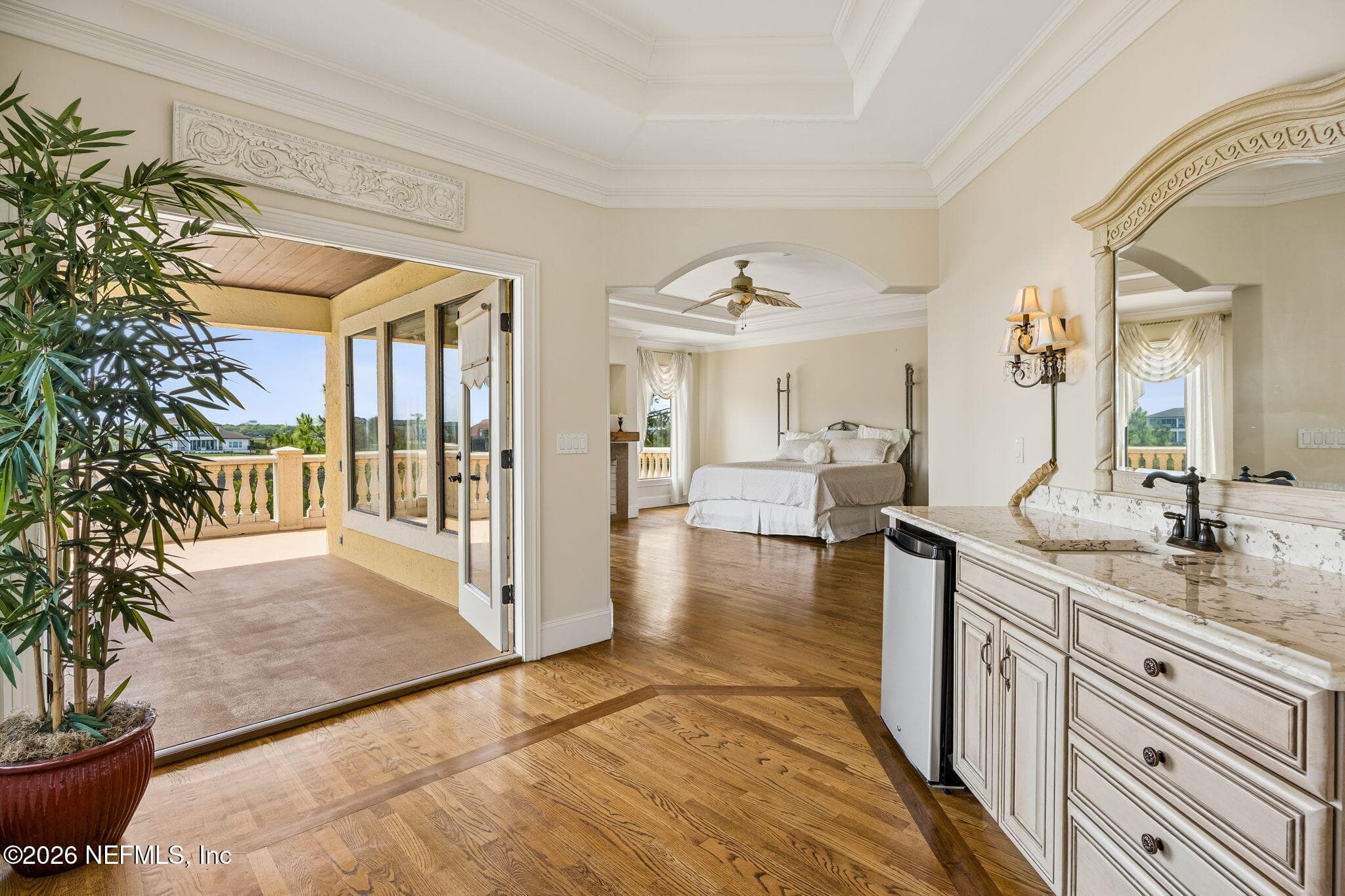 The primary bedroom features a wet bar/coffee bar, along with access to a private balcony that creates a peaceful retreat with seamless indoor-outdoor living. — 430 ROYAL TERN Road S, Jacksonville Beach, FL 32250