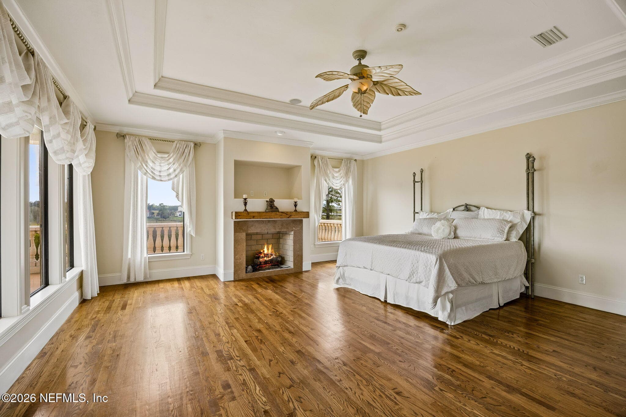 The primary bedroom features a cozy fireplace, adding warmth and elegance to the private retreat. — 430 ROYAL TERN Road S, Jacksonville Beach, FL 32250