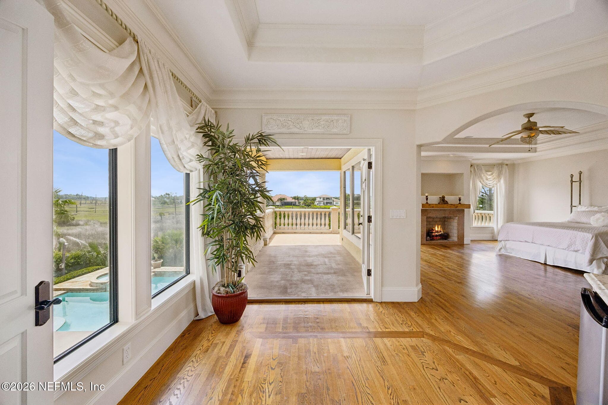 The primary bedroom includes access to a private balcony, providing a quiet escape to relax and enjoy the surrounding views. — 430 ROYAL TERN Road S, Jacksonville Beach, FL 32250