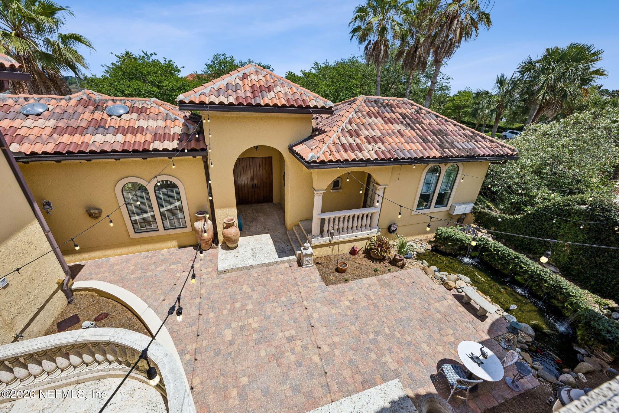A charming courtyard provides a private open-air setting with elegant hardscaping and a serene atmosphere ideal for enjoying the outdoors. — 430 ROYAL TERN Road S, Jacksonville Beach, FL 32250