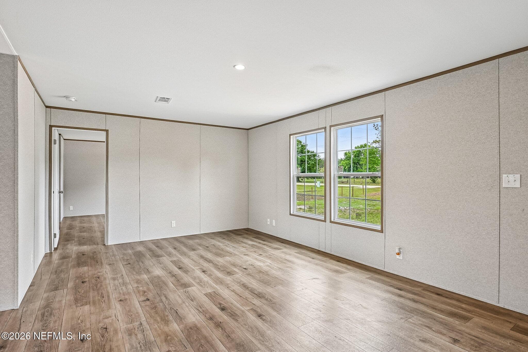 living room (heads to primary bedroom) split floor plan — 6771 SW COUNTY ROAD 225, Starke, FL 32091