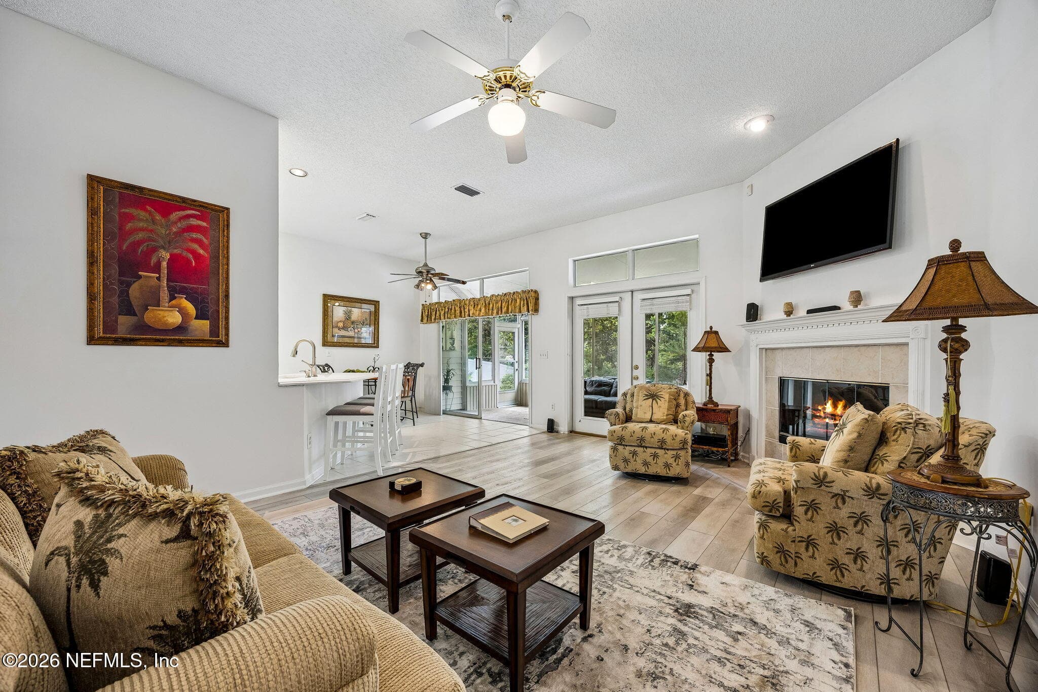 Living Room with fireplace and access to the Florida Room for ease of entertaining and relaxing — 865 LAGUNA Drive, Fernandina Beach, FL 32034