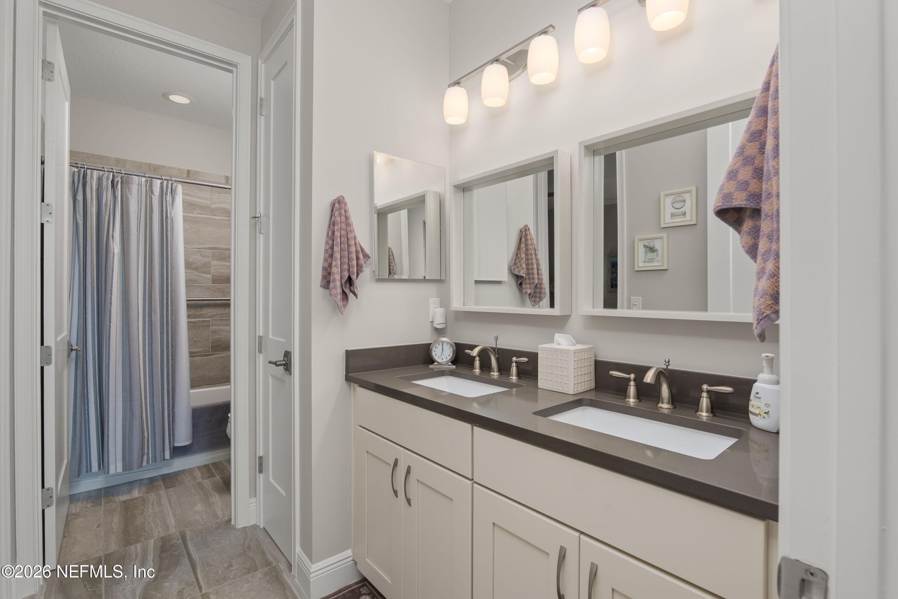Jack and Jill Bathroom with double vanities, private shower and linen closet — 703 RUM RUNNER Way, St. Johns, FL 32259