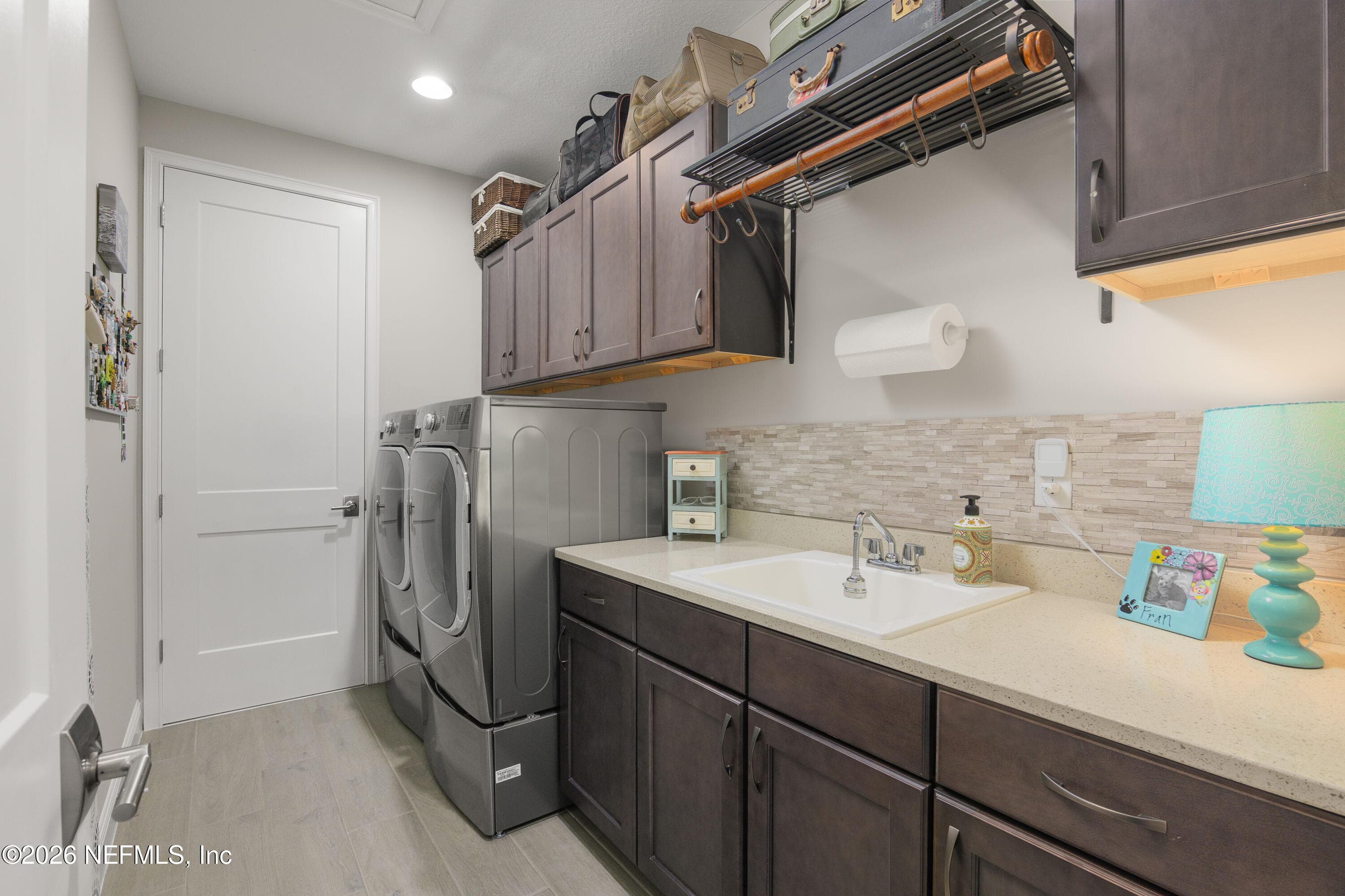 Large upstairs laundry with sink, plenty of cabinets and beautiful washer and dryer with pedestals that stay with the house! — 703 RUM RUNNER Way, St. Johns, FL 32259