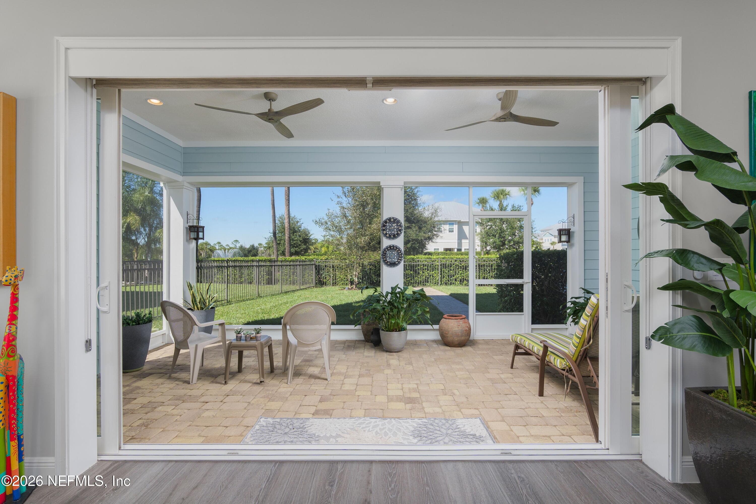 Disappearing sliding doors for a wide open space to the outdoors screened lania. The ultimate in Florida living! — 703 RUM RUNNER Way, St. Johns, FL 32259