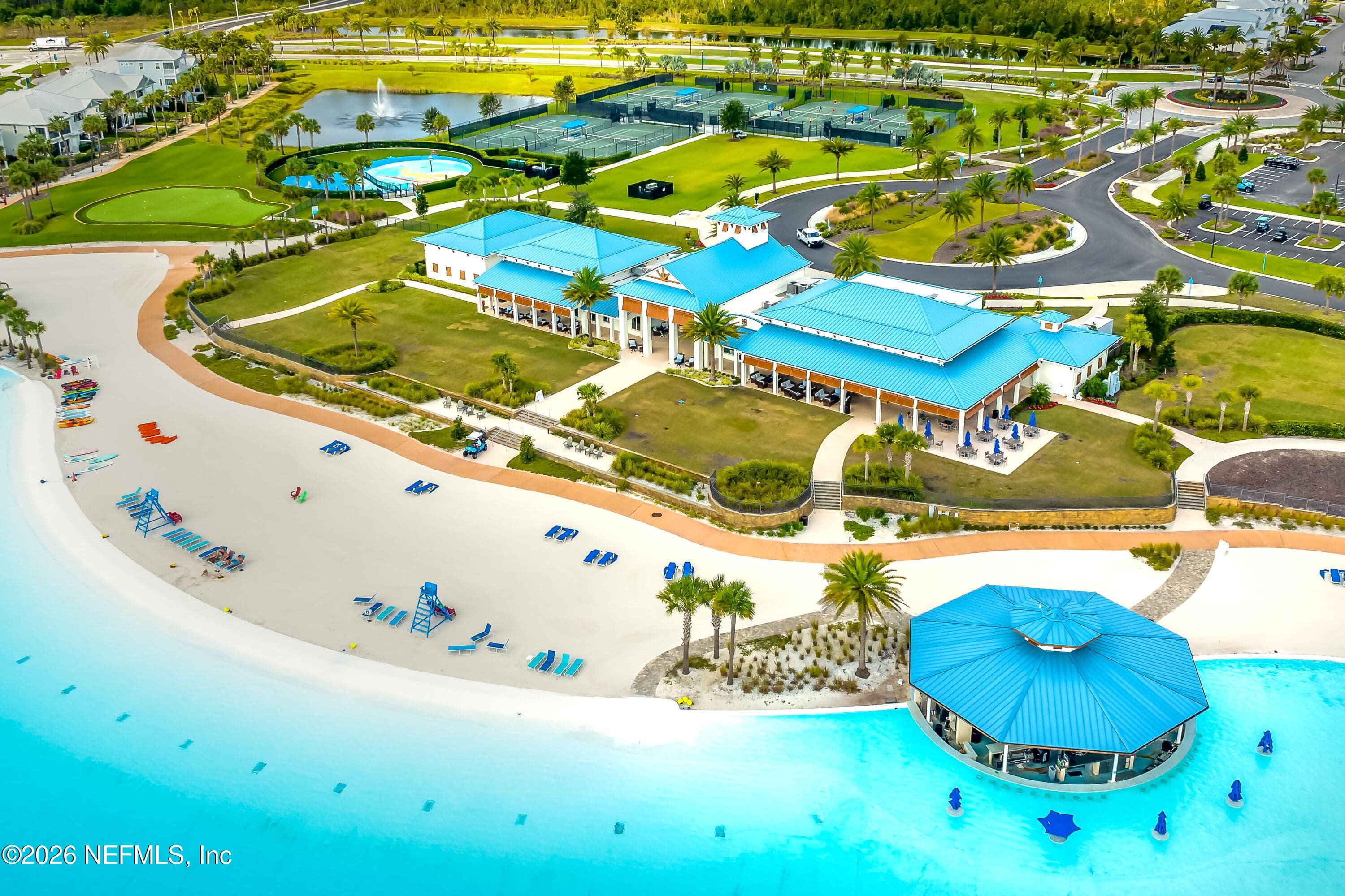 Expansive lagoon showing clubhouse, main beach and swim up bar — 703 RUM RUNNER Way, St. Johns, FL 32259
