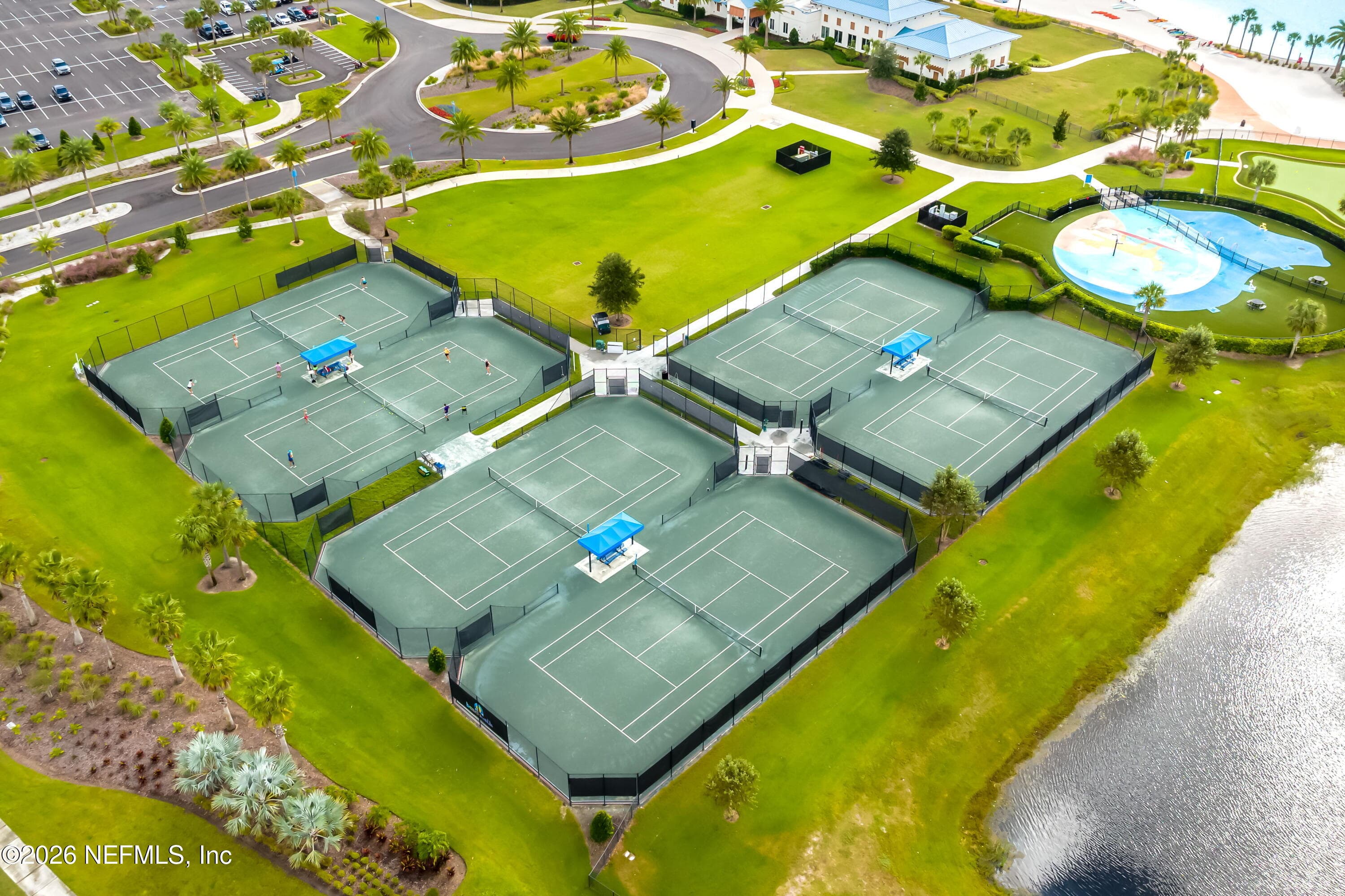 6 lighted Har-Tru tennis courts, open grassy area to play, dog splash park and 18 hole putting green — 703 RUM RUNNER Way, St. Johns, FL 32259