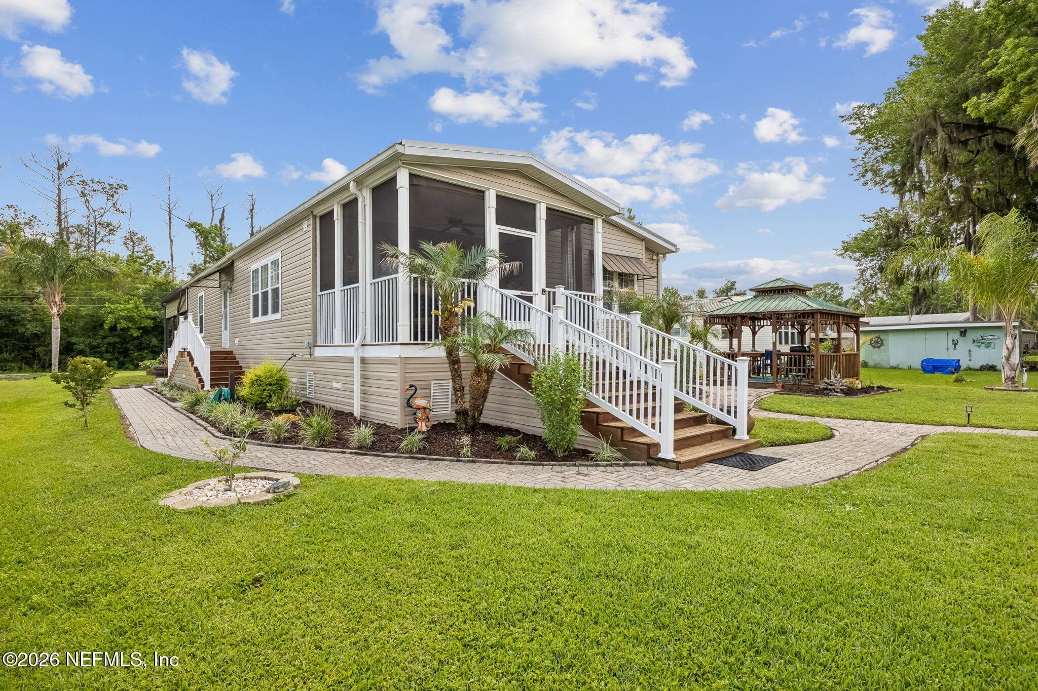Exit From Porch Overlooks Tastefully Maintained Yard — 329 PARADISE Circle, Satsuma, FL 32189