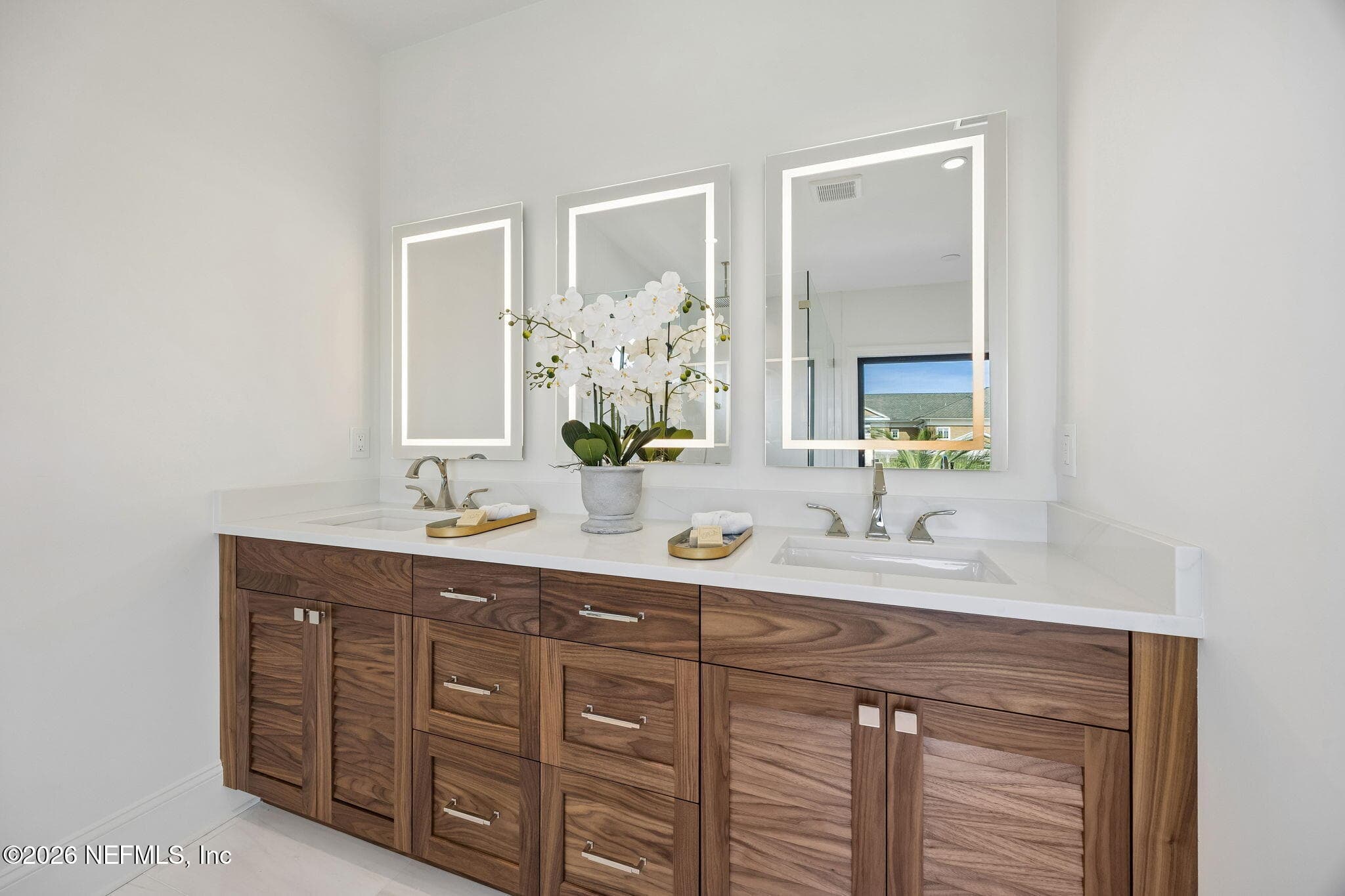 Walnut louvre-door vanity with dual sinks, a quartz countertop, and luminous
LED Mirrors — 730 PONTE VEDRA Boulevard, Ponte Vedra Beach, FL 32082