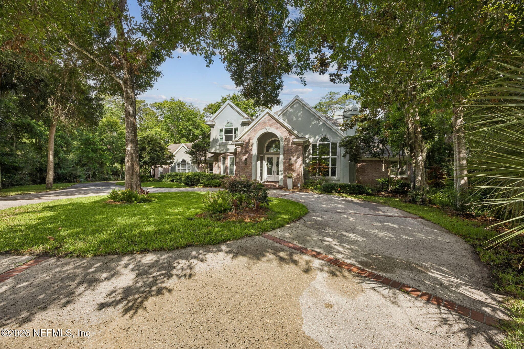 Framed by mature trees and lush landscaping, this elegant estate offers a private setting with a stately circular driveway and timeless curb appeal. — 5070 BENTGRASS Circle, Ponte Vedra Beach, FL 32082
