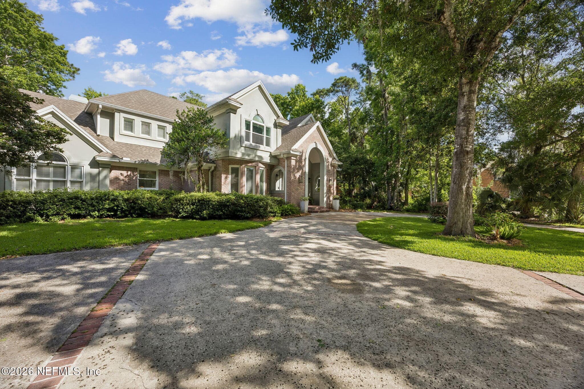 Set on a beautifully wooded homesite, this impressive residence combines classic architecture with exceptional privacy and charm. — 5070 BENTGRASS Circle, Ponte Vedra Beach, FL 32082