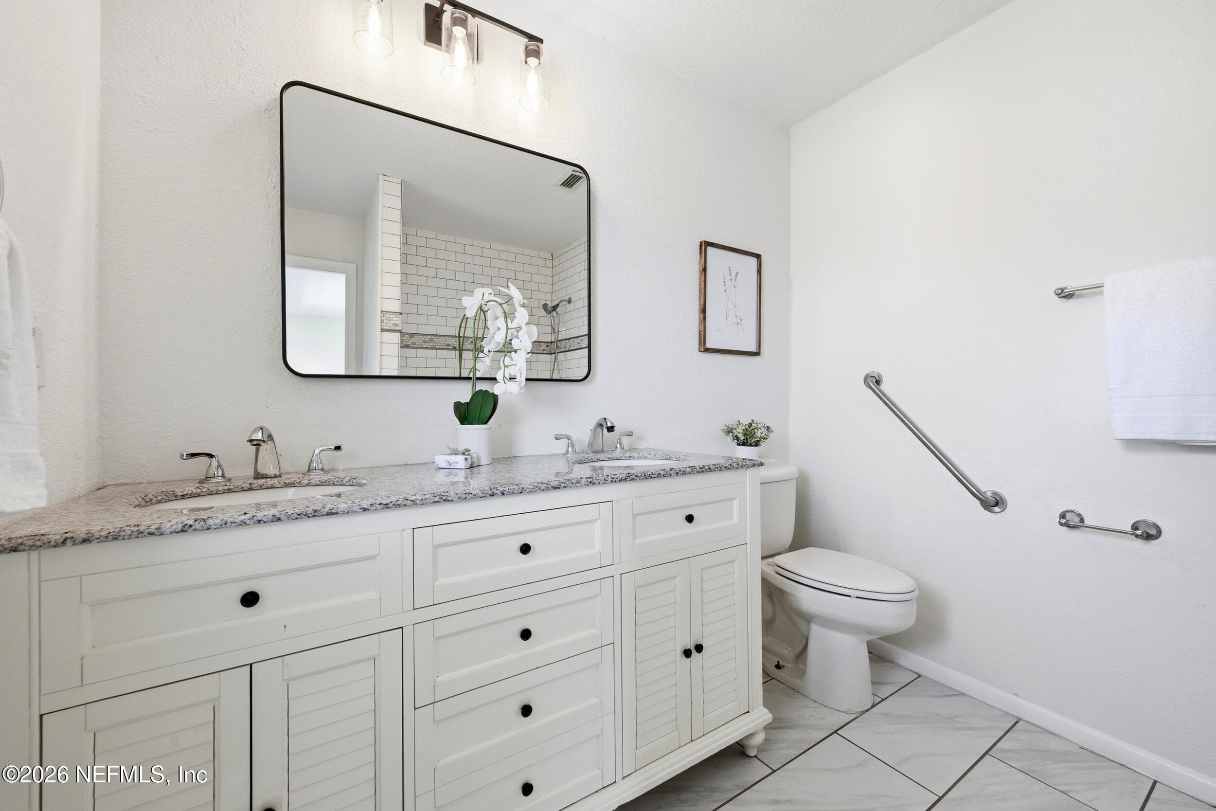 The spacious primary bath features dual vanities with abundant storage and a large walk-in shower designed for comfort and convenience. — 695 N A1A 25, Ponte Vedra Beach, FL 32082